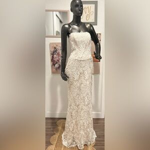 Elegant strapless lace wedding gown by Impression Bridal.